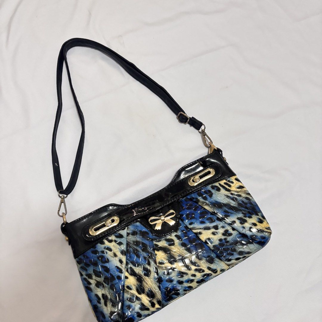 Y2K Leopard Print Shoulder Bag (Category: Shoulder Bags) located in Imus. Submitted by wear.arca (Listing ID 1468825387, Image 3). Description: - So cute and print is sooo nice - Eye-catching blue and black animal print with a glossy finish - Elegant gold-tone hardware and decorative front bow - Structured bottom with trendy pleated paneling.