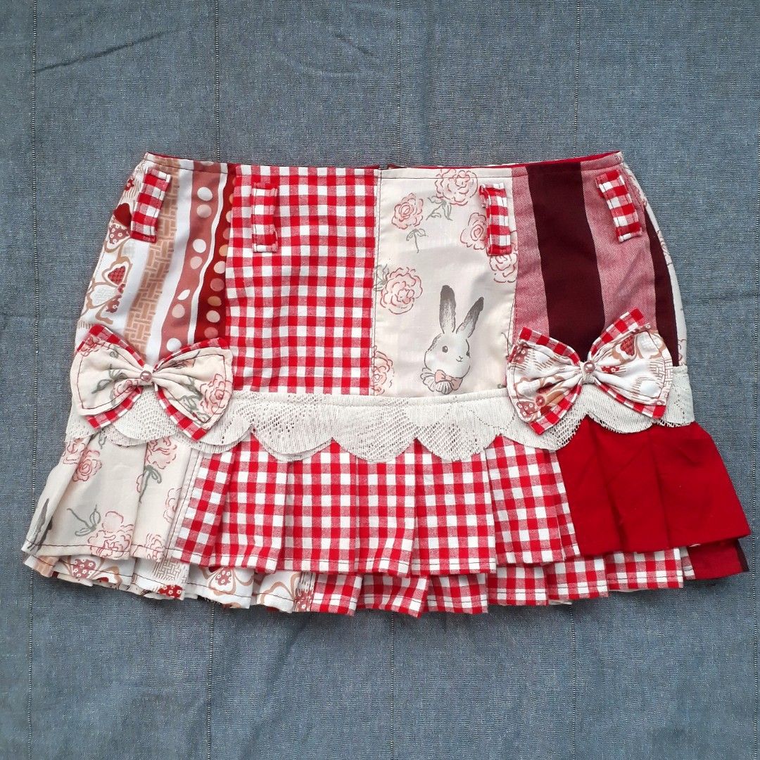 Y2K Red Patchwork Pleated Mini Skirt (Category: Skirts) located in Cabanatuan. Submitted by madeby_csnstudio (Listing ID 1468730788, Image 2). Description: MEASUREMENTS: Waist: 29 inches (73.66 cm) Hips: 36 inches (91.44 cm) Length: 13 inches (33.02 cm) DETAILS: The design features a playful blend of bright red gingham, polka dots, striped/solid red panels, delicate floral prints, and a whimsical illustrated bunny motif. Built-in belt loops frame