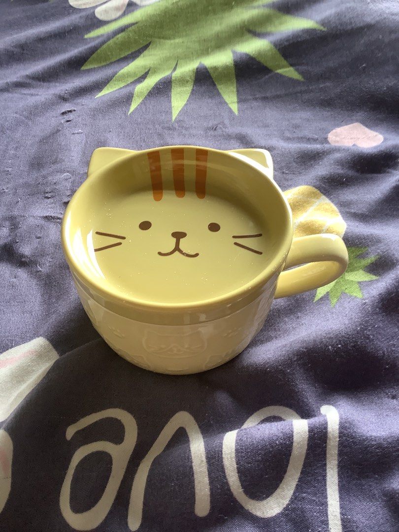 Yellow Cat Mug and Matching Cat Face Dish Set (Category: Coffee & Tea Tableware) located in Manila. Submitted by yugixoama95259 (Listing ID 1468742015, Image 2). Description: - Matching yellow ceramic mug and small dish set - Adorable cat-face dish complete with cute ears and whiskers - Simple, comfortable round mug with a side handle - Vibrant pastel yellow color to brighten your kitchen - Perfect for morning coffee, tea, or serving small snacks