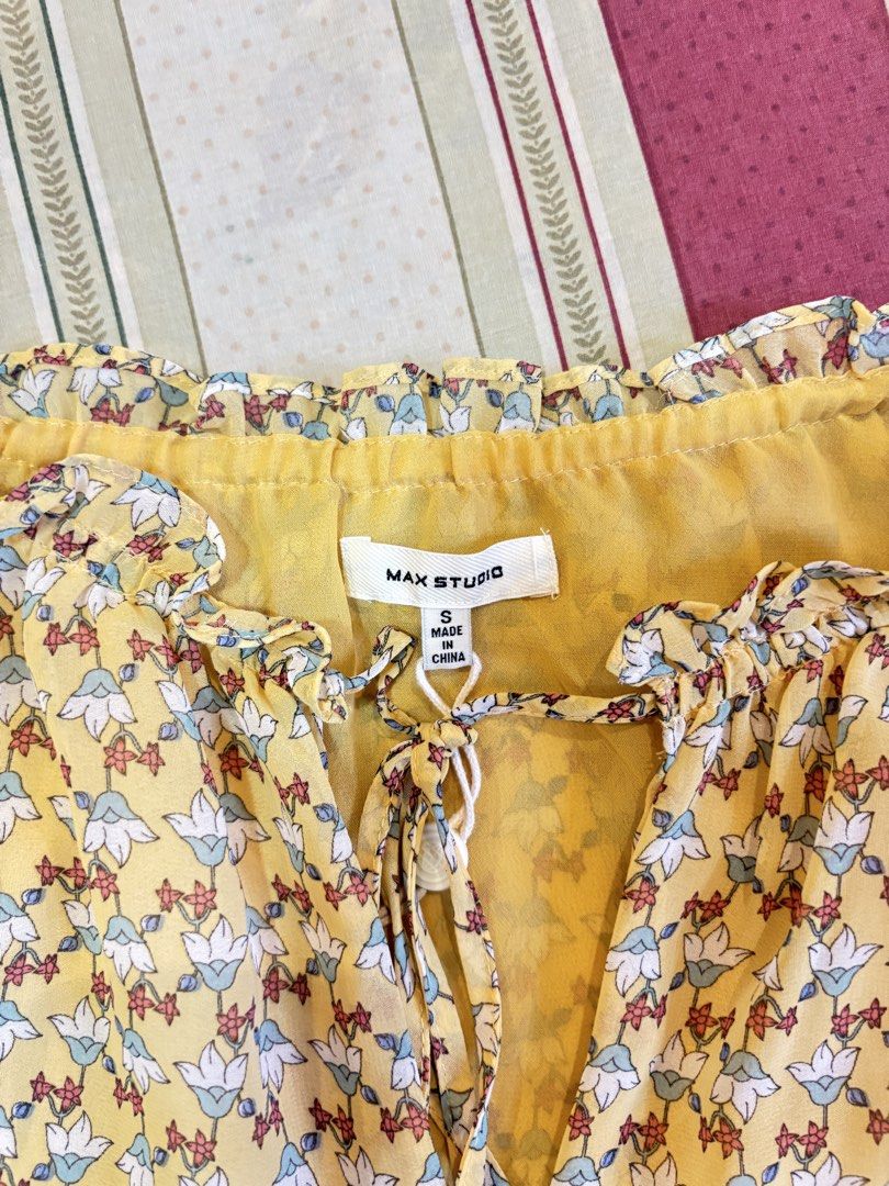 Yellow Floral Sleeveless Ruffle Blouse (Category: Blouses) located in Caloocan City. Submitted by joannarms320722 (Listing ID 1468781427, Image 3). Description: - Color/Pattern: Yellow with a tiny all-over floral print - Size: Small - Style: Sleeveless with a V-neckline and ruffled collar - Details: Thin front tie closure - Fabric: Light and airy, great for warm weather or layering.