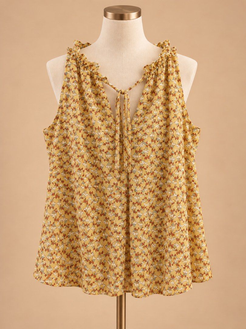 Yellow Floral Sleeveless Ruffle Blouse (Category: Blouses) located in Caloocan City. Submitted by joannarms320722 (Listing ID 1468781427, Image 1). Description: - Color/Pattern: Yellow with a tiny all-over floral print - Size: Small - Style: Sleeveless with a V-neckline and ruffled collar - Details: Thin front tie closure - Fabric: Light and airy, great for warm weather or layering.