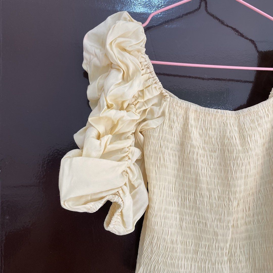 Yellow smocked puff sleeve top (Category: Blouses) located in Pasay City. Submitted by lovedbyzea (Listing ID 1468785040, Image 3). Description: - with fre dot stains, needs wash - Colour: Cream - Style: Crop top with square neckline and frilly hem - Fit: Super stretchy smocked bodice, easy to slip on and off - Details: Dramatic puff sleeves with ruching and ruffles - Pairing: Looks great with high-waisted jeans or skirts - Condition: Worn a few 
