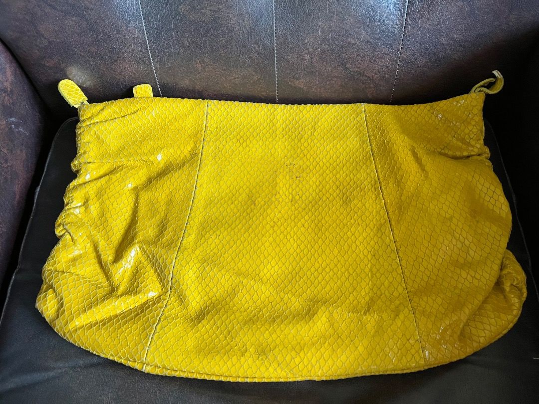 Yellow snakeskin print clutch/envelope bag (Category: Clutches) located in Makati City. Submitted by Ina_Ndang (Listing ID 1468714243, Image 2). Description: Yellow snakeskin print clutch/envelope bag Can be used as ipad bag Rubs on corner due to age and usage Approx. dimension: 15.5" (W), 10.2" (H) Payment thru Gcash Shipping thru J&T or depending on available courier NO RUSH shipping NO RETURN.