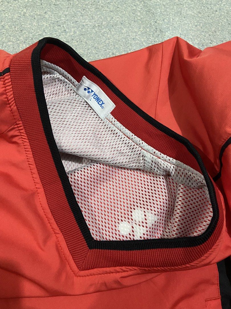Yonex V-Neck Windbreaker Jacket Red Black Size L (Category: Coats, Jackets and Outerwear) located in Baguio. Submitted by chicoroy (Listing ID 1468882473, Image 3). Description: - Brand: Yonex - Style: Windbreaker / Athletic Jacket - Color: Vibrant Red with Black side panels and trim - Size: L (Tag size) Dimes:23.5/27 Need wash - Material: 100% Polyester (Shell and lining) - Features: Classic V-neck collar, breathable mesh inner lining, embroider