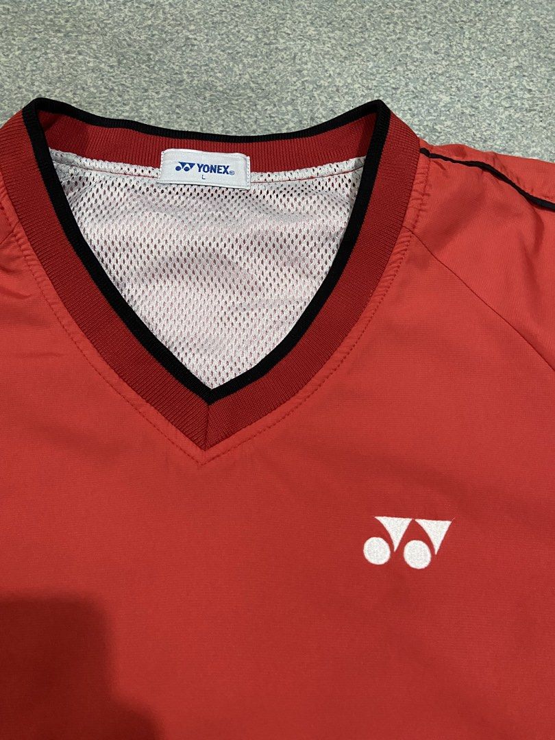 Yonex V-Neck Windbreaker Jacket Red Black Size L (Category: Coats, Jackets and Outerwear) located in Baguio. Submitted by chicoroy (Listing ID 1468882473, Image 2). Description: - Brand: Yonex - Style: Windbreaker / Athletic Jacket - Color: Vibrant Red with Black side panels and trim - Size: L (Tag size) Dimes:23.5/27 Need wash - Material: 100% Polyester (Shell and lining) - Features: Classic V-neck collar, breathable mesh inner lining, embroider