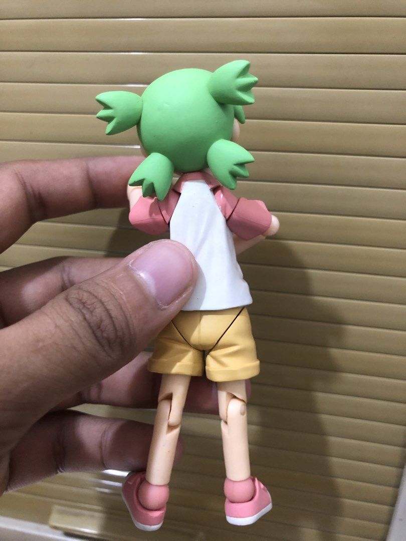 Yotsuba Koiwai Action Figure Revoltech (Category: Figurines & Statues) located in Caloocan City. Submitted by vansellstuff123 (Listing ID 1468759927, Image 3). Description: - Character: Yotsuba Koiwai from Yotsuba&! - Outfit: White and pink raglan shirt, yellow shorts, and pink sneakers - Features: Fully articulated arms and legs, signature green hair with four pigtails, and a grumpy facial expression - Standability: Stands nicely on flat surface