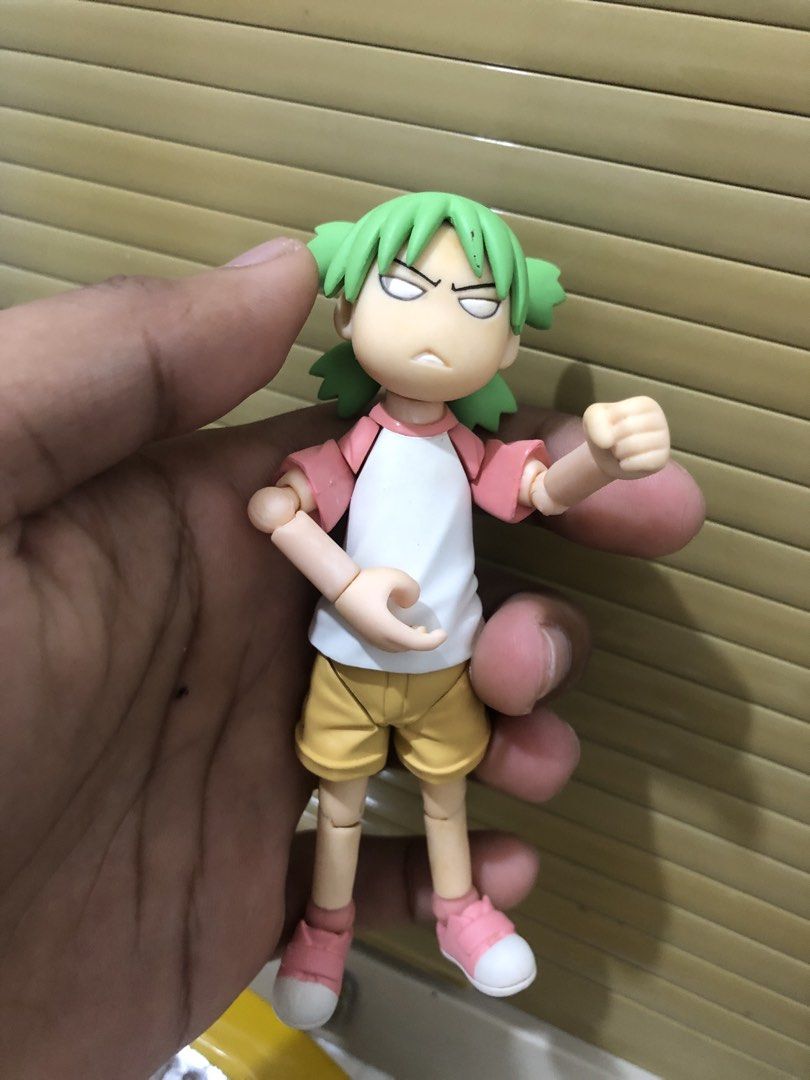 Yotsuba Koiwai Action Figure Revoltech (Category: Figurines & Statues) located in Caloocan City. Submitted by vansellstuff123 (Listing ID 1468759927, Image 2). Description: - Character: Yotsuba Koiwai from Yotsuba&! - Outfit: White and pink raglan shirt, yellow shorts, and pink sneakers - Features: Fully articulated arms and legs, signature green hair with four pigtails, and a grumpy facial expression - Standability: Stands nicely on flat surface