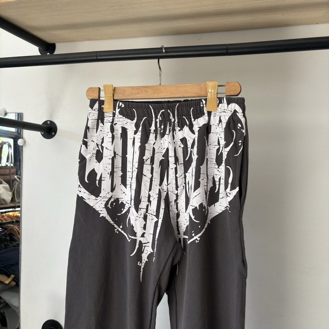 YoungLA Graphic Sweatpants Dark Grey Size S (Category: Joggers) located in Bambang. Submitted by heats777 (Listing ID 1468817564, Image 1). Description: - Brand: YoungLA - Color: Dark Grey - Size: Small - Design: Large white distressed graphic print across the front waist - Fit: Relaxed fit with a comfortable elastic waistband - Details: Single back pocket with small YoungLA branding - Material: Soft cotton blend interior - Style: Great streetwea