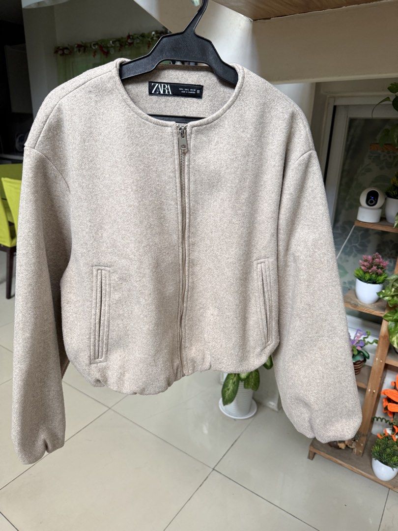 Zara Beige Wool Blend Zip Bomber Jacket Size L (Category: Coats, Jackets and Outerwear) located in Manila. Submitted by clalala.fire (Listing ID 1468875273, Image 1). Description: - Brand: Zara - Style: Zip-up bomber jacket - Color: Oatmeal beige - Size: L - Details: Round neckline, full metal front zipper, two side welt pockets, gathered cuffs, elasticized back hem - Material: Soft, textured wool-like fabric - Condition: Clean, smoke-free home.