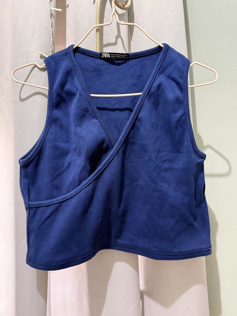 ZARA Blue Ribbed Wrap Crop Top Size M (Category: Sleeveless) located in Cagayan de Oro. Submitted by ninaaam (Listing ID 1468766053, Image 2). Description: - Brand: Zara - Color: Deep Blue - Size: XL - Material: Comfortable ribbed knit stretch fabric - Design: Wrap front with V-neckline and sleeveless style - Condition: Clean and ready to wear.