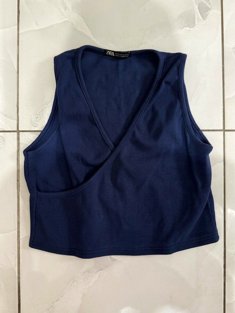 ZARA Blue Ribbed Wrap Crop Top Size M (Category: Sleeveless) located in Cagayan de Oro. Submitted by ninaaam (Listing ID 1468766053, Image 1). Description: - Brand: Zara - Color: Deep Blue - Size: XL - Material: Comfortable ribbed knit stretch fabric - Design: Wrap front with V-neckline and sleeveless style - Condition: Clean and ready to wear.