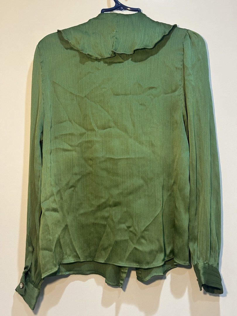Zara Green Ruffle Collar Blouse Size S (Category: Blouses) located in Taguig. Submitted by ellajanee (Listing ID 1468766387, Image 2). Description: - Brand: Zara - Size: S - Made in Turkey - Color: Green - Design: Button-up front with sparkly crystal buttons - Details: Oversized ruffle collar with matching neckline tie and textured fabric throughout - Sleeves: Long sleeves with button cuffs - Versatility: Perfect for office wear or dressing up fo