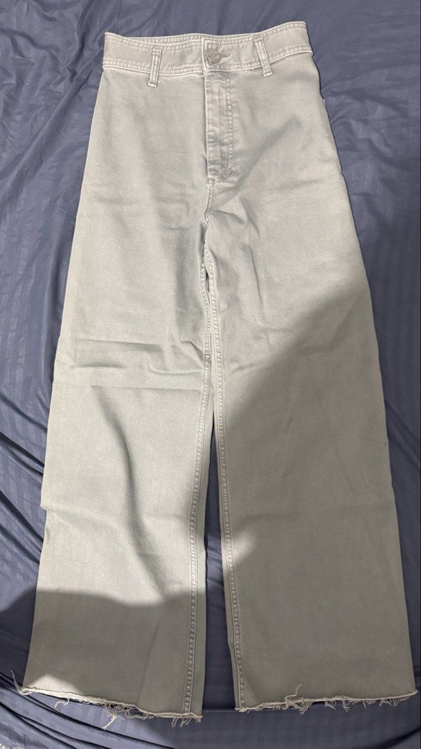 Zara Grey Wide Leg Pants Size (Category: Jeans) located in Quezon City. Submitted by danieclutters (Listing ID 1468829540, Image 1). Description: - Brand: Zara - Color: Grey - Fit: High waist with wide leg - Details: Belt loops, front button closure, raw hem, two large back pockets - Origin: Made in Pakistan - Condition: Good, with a small ink stain near the lower side seam - Style: Perfect casual bottoms for everyday outfits .