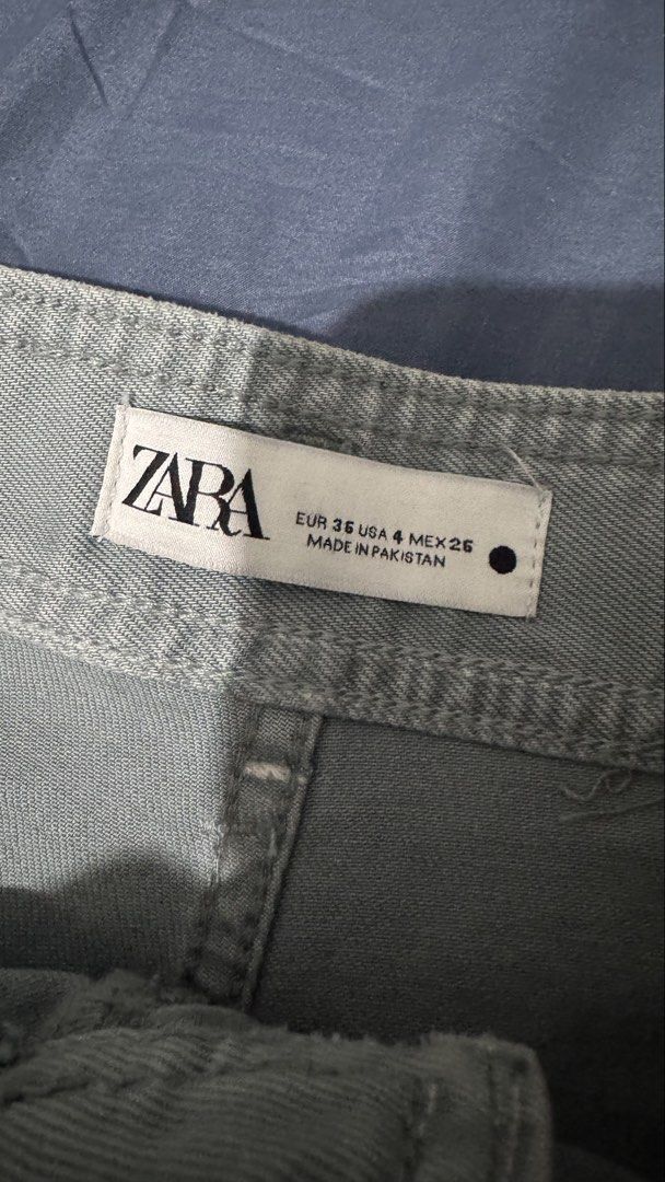 Zara Grey Wide Leg Pants Size (Category: Jeans) located in Quezon City. Submitted by danieclutters (Listing ID 1468829540, Image 2). Description: - Brand: Zara - Color: Grey - Fit: High waist with wide leg - Details: Belt loops, front button closure, raw hem, two large back pockets - Origin: Made in Pakistan - Condition: Good, with a small ink stain near the lower side seam - Style: Perfect casual bottoms for everyday outfits .