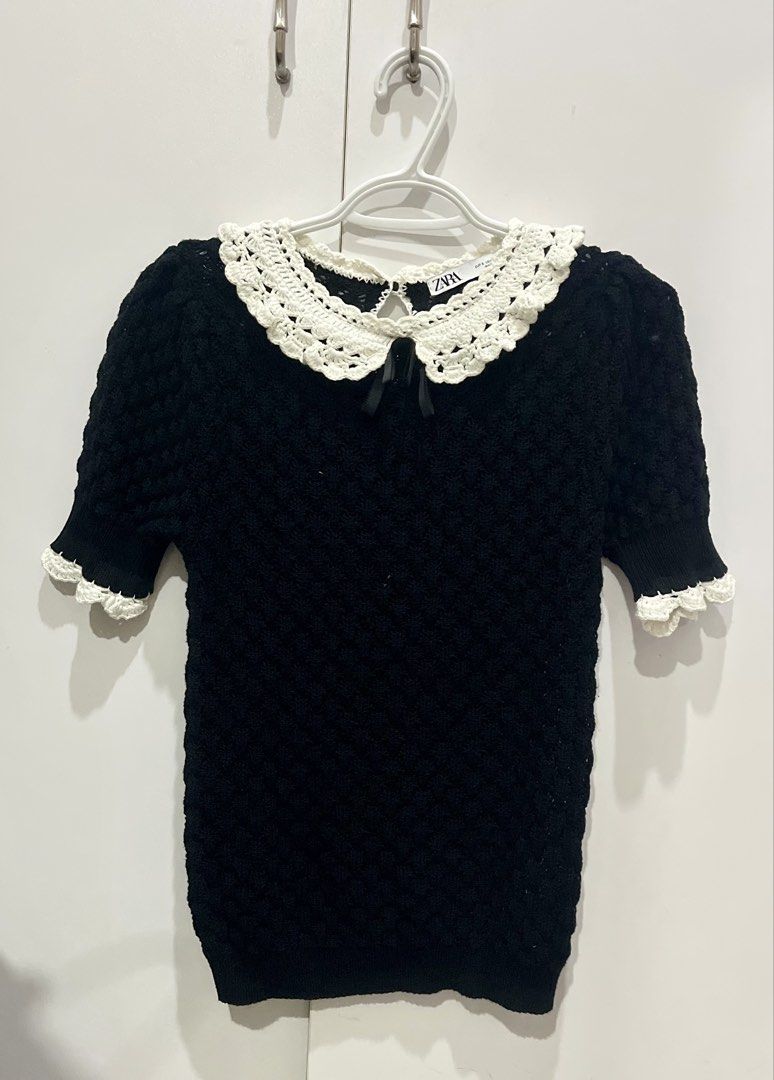 Zara Knitted Peter Pan collar top (Category: Blouses) located in Marikina City. Submitted by charmhazel_ (Listing ID 1468830346, Image 1). Description: -Black short-sleeved knit top featuring a textured openwork design, a contrasting white crochet/lace Peter Pan collar, and a small black bow detail at the neckline - can fit small fo med.