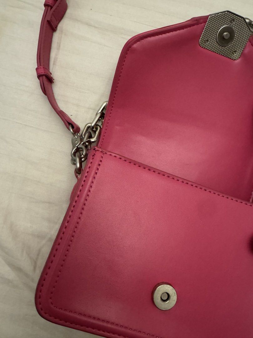 Zara Pink Crossbody Bag With Chain Strap (Category: Cross-body Bags) located in Marikina City. Submitted by kaceinpoint (Listing ID 1468803716, Image 3). Description: - Brand: Zara - Color: Bright pink - Closure: Secure magnetic front flap - Straps: Chunky silver chain handle and an adjustable matching pink shoulder strap - Interior: Black fabric lining with Zara logo tag and product care tag - Condition: Clean interior and exterior.