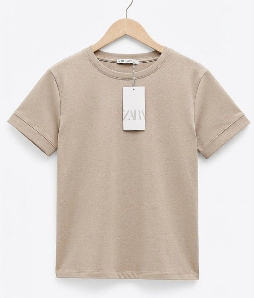 ZARA Short Sleeves Cotton Tops (Category: Shirts) located in Quezon City. Submitted by panapton.ph (Listing ID 1466784757, Image 2). Description: -FLASH SALE ONLY 250 -Brand: Zara -Brandnew with Hangtag -Actual item post -​Color: Neutral taupe / beige -Size fit 34 to 44bust -​Style: Classic crew neckline, short sleeves with subtle stitched cuff details, and a straight hem -​Fit: Regular, comfortable fit that looks great worn tucked in or loose -P