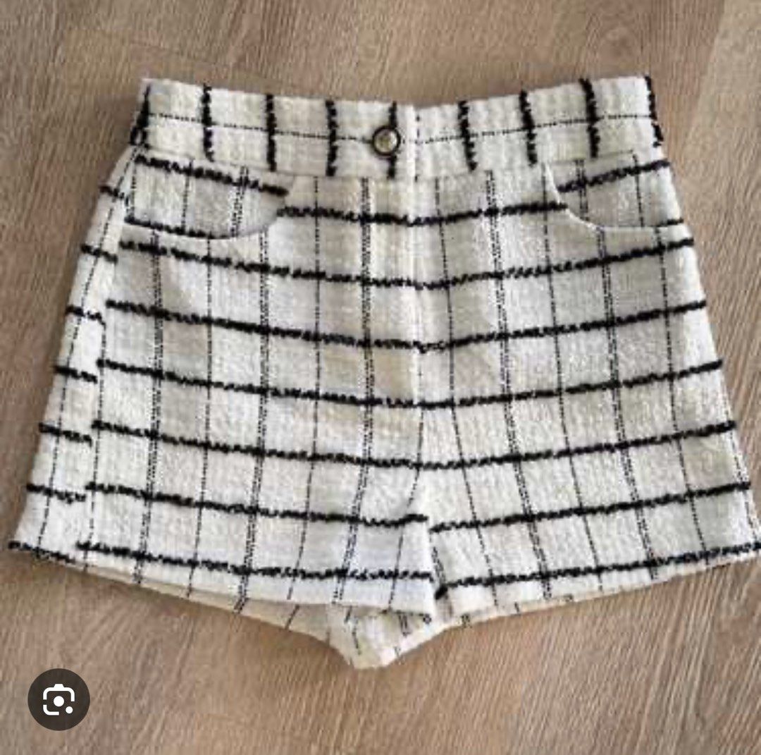 Zara Tweed Check Shorts (Category: Shorts) located in Caloocan City. Submitted by athenaxartemis (Listing ID 1468846560, Image 1). Description: - Style: Chic high-waisted shorts with a structured fit - Material: Textured tweed fabric - Pattern: Classic black and white check - Features: Front button closure, belt loops, and deep front pockets - Condition: Worn once, still in great shape - Pairing: Looks great with boots or heels.