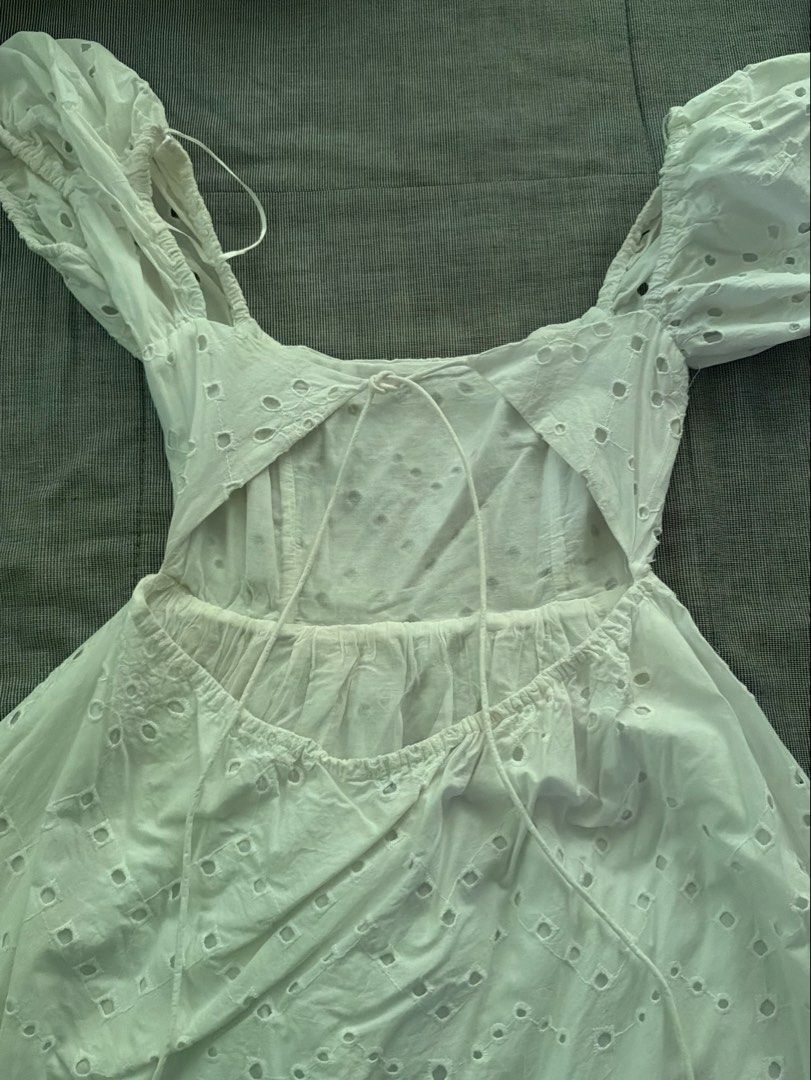 Zara White Backless Dress Size S (Category: Dresses) located in Manila. Submitted by jaehyun2829 (Listing ID 1468736699, Image 2). Description: - Brand: Zara - Style: White eyelet dress with puff sleeves and square neckline - Details: Back cutout with tie closure, gathered waist, and flared skirt - Material: Light cotton (Made in India) - Size: S - Worn once .