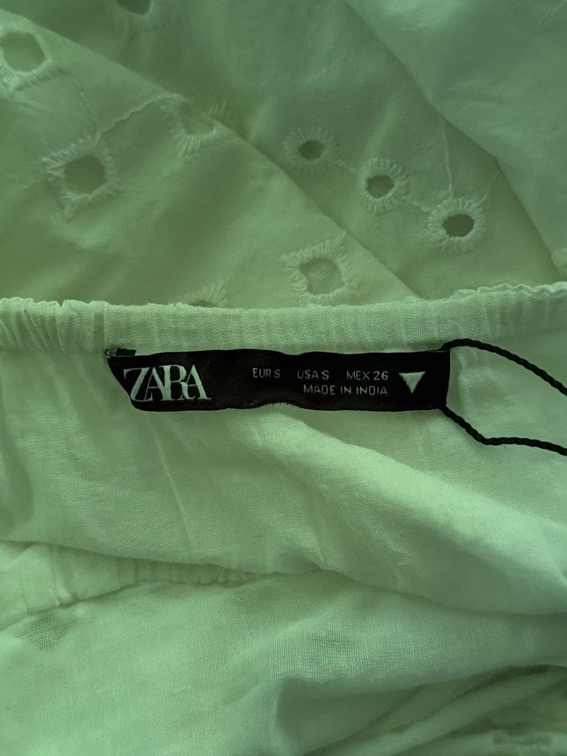 Zara White Backless Dress Size S (Category: Dresses) located in Manila. Submitted by jaehyun2829 (Listing ID 1468736699, Image 3). Description: - Brand: Zara - Style: White eyelet dress with puff sleeves and square neckline - Details: Back cutout with tie closure, gathered waist, and flared skirt - Material: Light cotton (Made in India) - Size: S - Worn once .