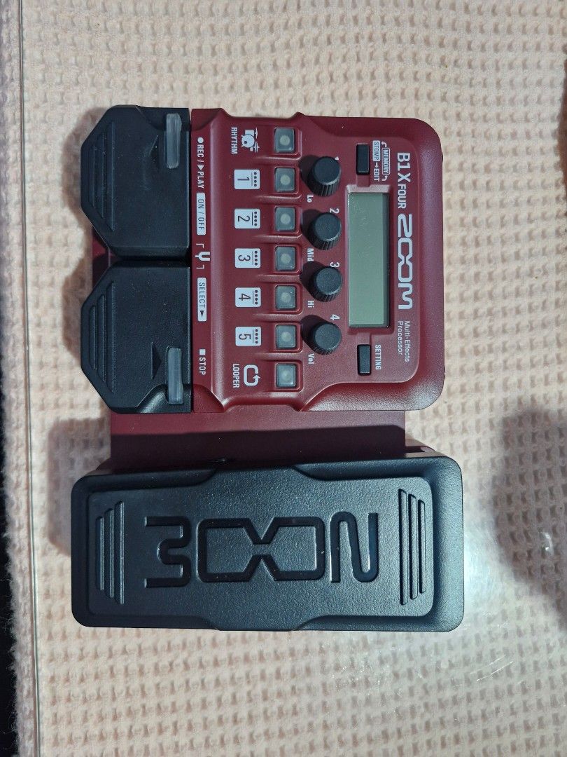Zoom B1X Four Bass Multi-Effects with Expression Pedal (Category: Musical Instruments) located in Manila. Submitted by tigasorda61186 (Listing ID 1468751373, Image 1). Description: - Model: Zoom B1X Four Bass Multi-Effects Pedal - Color: Vibrant red chassis with black expression pedal and buttons - Features: Built-in expression pedal, diverse rhythm patterns, and looper function - Connectivity: Input, Aux-in, DC 5V, USB, and Output ports - Inclus