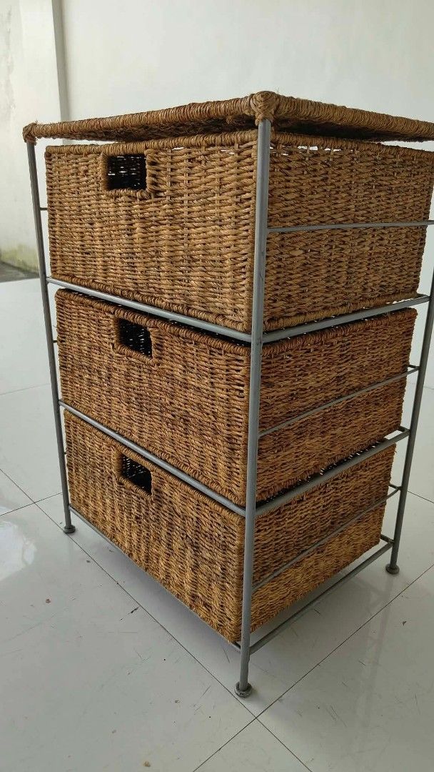 3-Tier Wicker Basket Storage Unit with Metal Frame (Category: Shelves, Cabinets & Racks) located in Manila. Submitted by roveeeeelen_06 (Listing ID 1469085034, Image 3). Description: - Set of 3 woven wicker baskets in a sturdy grey metal frame - Built-in cut-out handles for smooth and easy pulling - Flat top surface offers extra space for display or decor - Keeps clutter hidden while adding natural texture to your room - Clean condition overall a