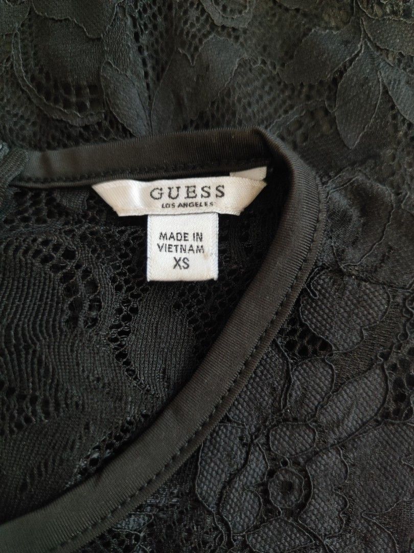 🖤 Authentic GUESS Black Lace Mini Dress ✨ (Category: Dresses) located in Kalibo. Submitted by cloth.ly (Listing ID 1468939065, Image 3). Description: 📏 Measurements: •Bust: 30" Waist: 24" Hips: 30" Length: 33" Shoulder Width: 10" Hem: 30" Size: US XS — fits Small Material: 88% Nylon + 12% Spandex — stretchy & comfy Origin: Made in Vietnam 🇻🇳 ✨ Details: • floral lace overlay — elegant & feminine 🥀 • Sleeveless high-neck design • Full-length b