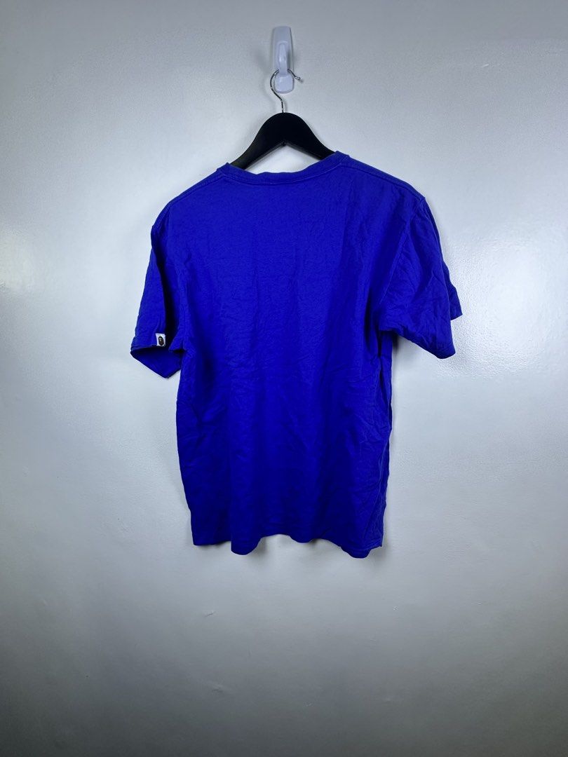 A Bathing Ape Blue Tee Size L (Category: Tshirts & Polo Shirts ) located in Manila. Submitted by declutterpromax (Listing ID 1468970021, Image 3). Description: - Brand: A Bathing Ape (BAPE) - Color: Blue (Solid back) - Size: L (Large) - Dimensions: 21" chest width x 27" length - Details: Large multicolored ape head graphic on front, sleeve logo tag, and classic inner collar tag - Condition: Excellent streetwear piece, ready to wear.