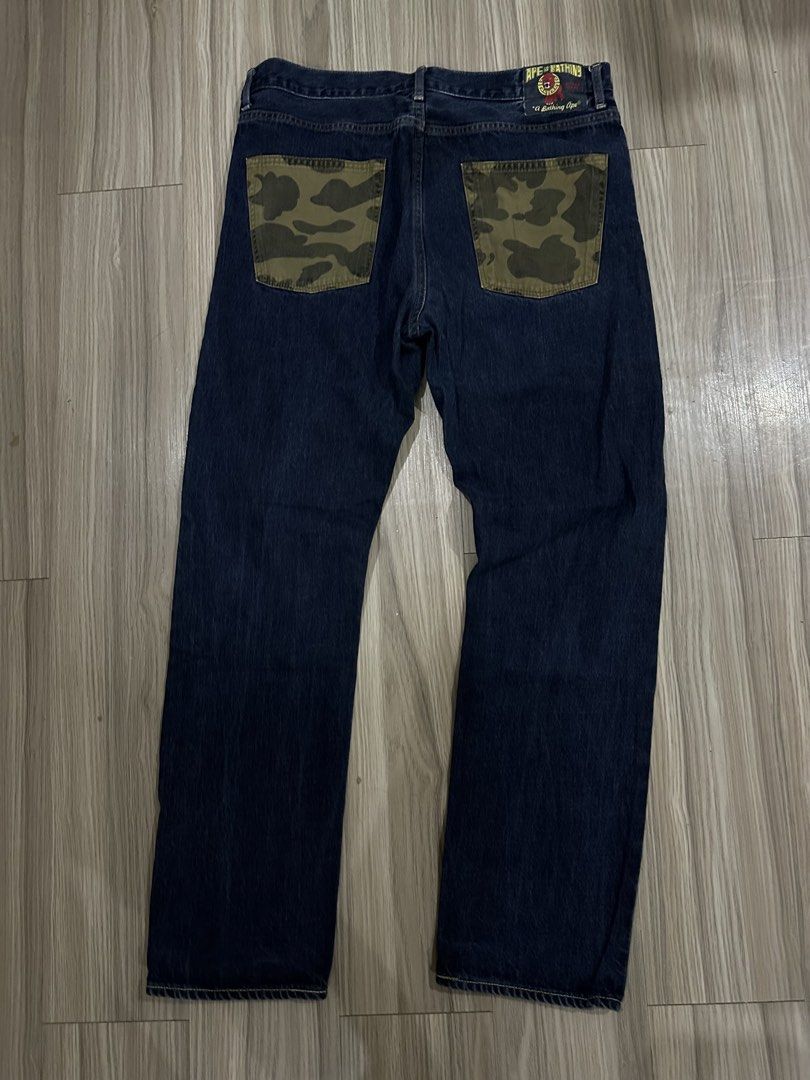 A Bathing Ape Denim Jeans with Camo Pockets (Category: Jeans) located in Quezon City. Submitted by stre3tw3ar (Listing ID 1468935627, Image 1). Description: - Brand: A Bathing Ape (BAPE) - Color: Dark blue denim with signature green camo on back pockets - Material: 100% premium cotton, Made in Japan - Fit: Classic straight leg cut - Details: Leather graphic back patch and interior wash/care tags attached - Condition: Excellent, ready to wear - Mo