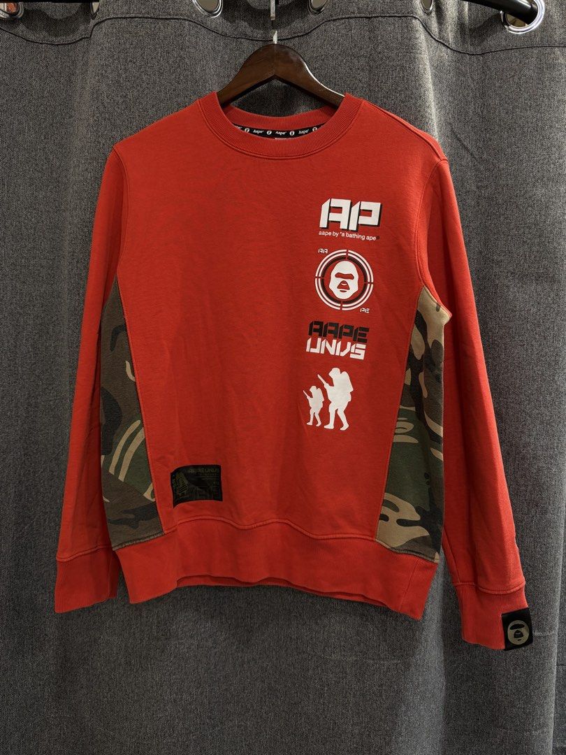 Aape (Authentic) (Category: Coats, Jackets and Outerwear) located in Quezon City. Submitted by macleen17 (Listing ID 1469014242, Image 1). Description: Aape Size M Excellent Condition Red Color Camo Design design Big Sleeve Tag .
