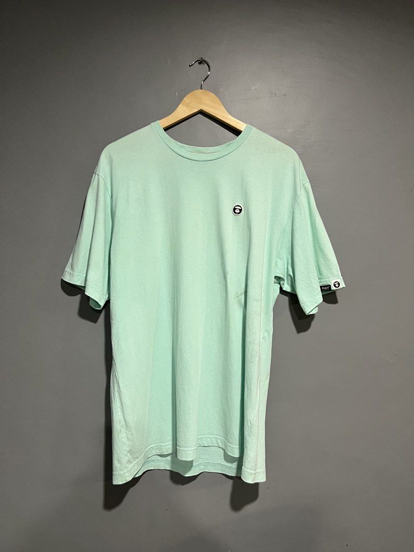 Aape By A Bathing Ape Mint Green T-Shirt (Category: Tshirts & Polo Shirts ) located in Maasin. Submitted by niconii090 (Listing ID 1468987316, Image 1). Description: - Brand: Aape by A Bathing Ape - Color: Mint Green - Size: XL - Material: 100% Cotton - Details: Embroidered chest monkey logo, branded sleeve tags, and Aape inner collar tape - Condition: Mint, with care tags attached.