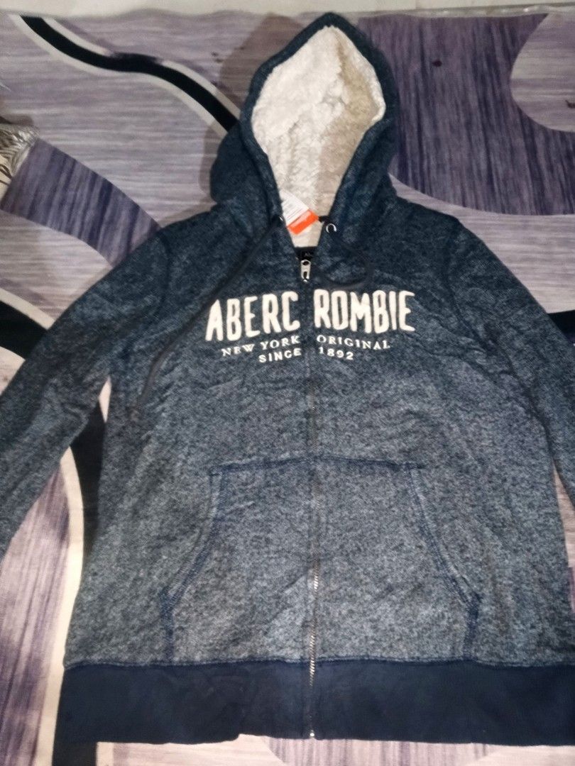 Abercrombie hoodie jacket (Category: Coats, Jackets and Outerwear) located in Manila. Submitted by icamalicdem29 (Listing ID 1468940947, Image 3). Description: vintage Abercrombie & Fitch Sherpa Lined Zip-Up Hoodie in heathered navy blue, featuring a fuzzy sherpa fleece lining inside the hood and body with a bold white "Abercrombie" logo spell-out across the chest..