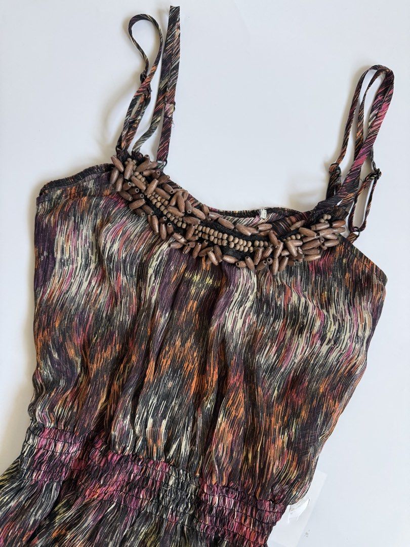 Abstract Print Beaded Halter Tank Top (Category: Sleeveless) located in Tarlac. Submitted by kr_closet (Listing ID 1468934514, Image 3). Description: - Style: Boho multi-color abstract print tank top - Details: Chunky wooden bead embellishment on neckline - Fit: Adjustable spaghetti straps and smocked elastic cinched waist - Design: Lightweight, flowy fabric with a high-low curved hemline.