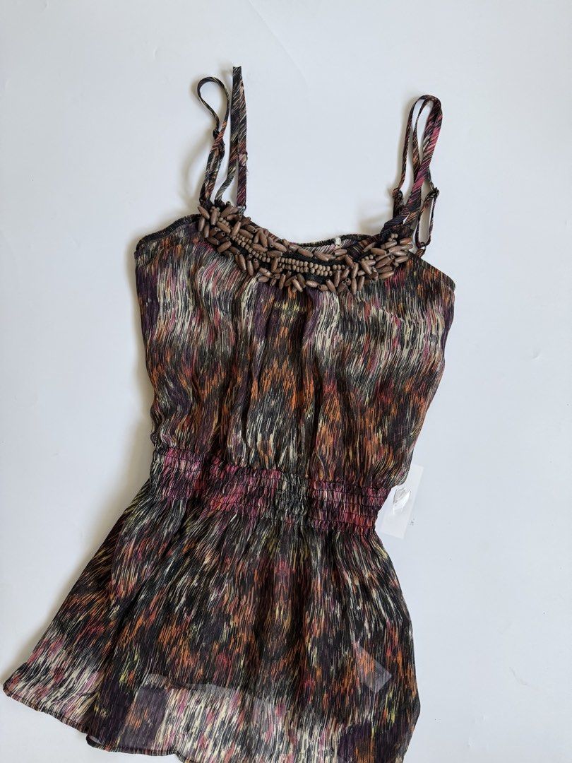 Abstract Print Beaded Halter Tank Top (Category: Sleeveless) located in Tarlac. Submitted by kr_closet (Listing ID 1468934514, Image 2). Description: - Style: Boho multi-color abstract print tank top - Details: Chunky wooden bead embellishment on neckline - Fit: Adjustable spaghetti straps and smocked elastic cinched waist - Design: Lightweight, flowy fabric with a high-low curved hemline.