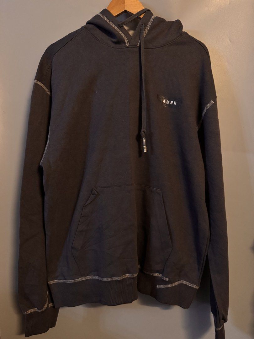 ADER error Contrast Stitching Hoodie (Category: Hoodies) located in Alaminos. Submitted by outfitcheck.ph (Listing ID 1469099974, Image 1). Description: - Brand: ADER error (2021 Spring/Summer Collection) - Color: Dark charcoal grey with contrast white stitching - Size: Oversized fit (Tag A2) - Material: Comfortable cotton fleece - Details: Small chest logo, branded drawstring hardware - Condition: Comes with original blue brand tags attached at 