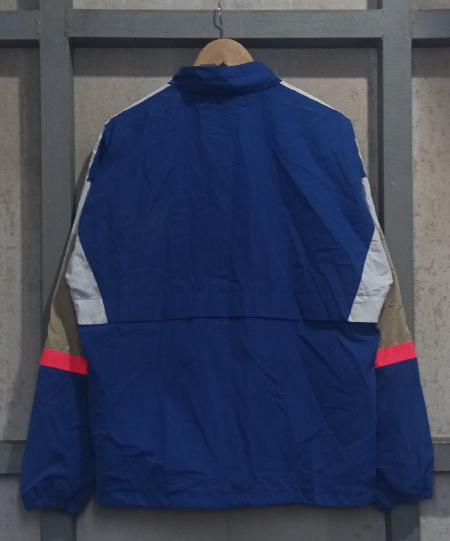 Adidas Blue Windbreaker Jacket (Category: Coats, Jackets and Outerwear) located in Muntinlupa City. Submitted by thriftben (Listing ID 1468930546, Image 2). Description: Blue Adidas windbreaker with white and tan stripes down the sleeves. Bright pink accent line near the cuffs. Full zip closure with zipped side pockets. Stand-up collar. Inner mesh lining. 100% recycled polyester construction. Made in China. Standard men's size M..