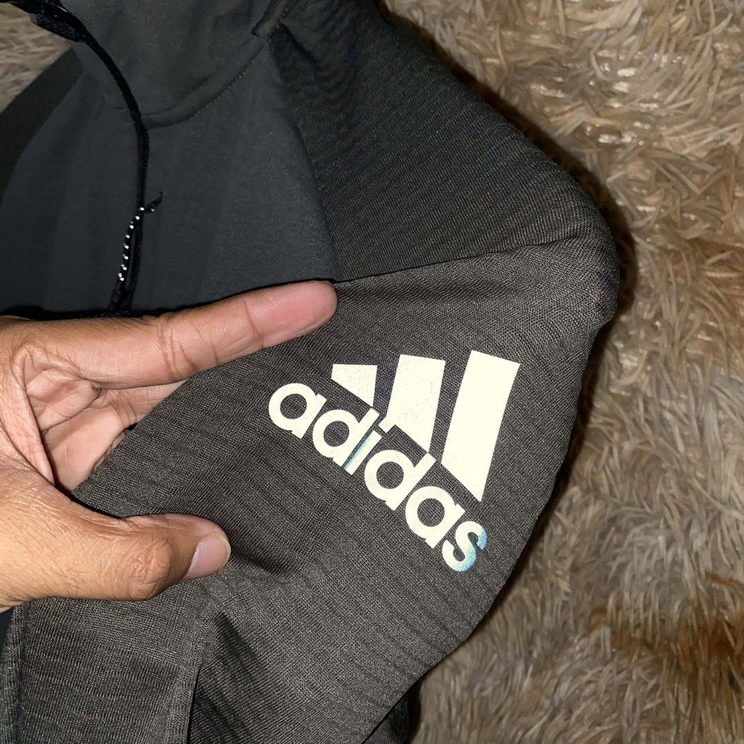 Adidas Dark Green Zip-Up Athletic Jacket (Category: Activewear) located in Butuan. Submitted by jc13thrifts (Listing ID 1469064030, Image 3). Description: - Color: Dark green - Design: Textured fabric panels, raglan sleeves, and subtle tonal Adidas logo on sleeve - Closure & Collar: Full zip closure with stand-up collar - Pockets: Two zippered side pockets plus a vertical chest pocket - Best for: Workouts, running errands, and cooler weather laye