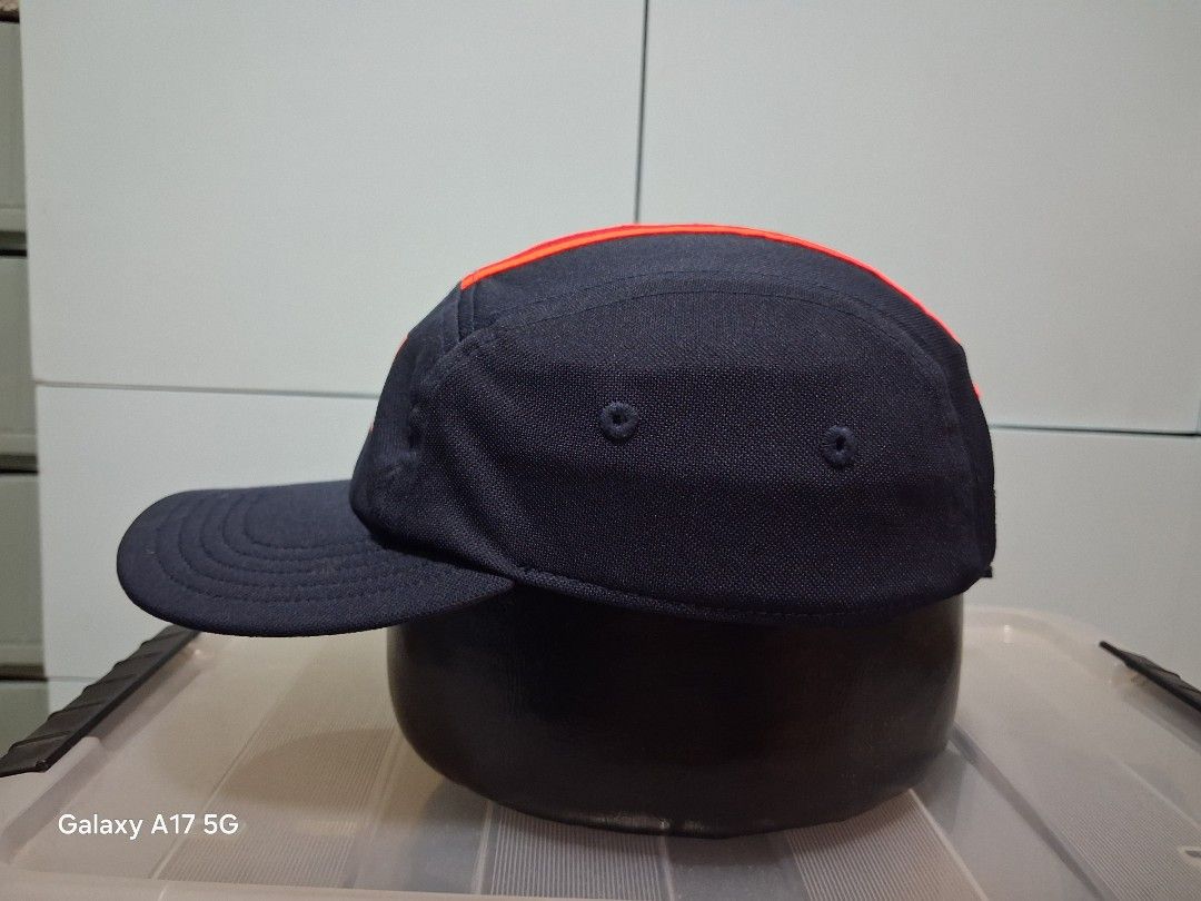 Adidas Dark Navy and Orange 5-Panel Cap (Category: Caps & Hats) located in Imus. Submitted by jefflac54673 (Listing ID 1468936790, Image 2). Description: - Brand: Adidas - Style: Navy blue five-panel cap with bright orange accents and center stripe - Logo: Striking orange Adidas box logo on front crown - Material: 100% polyester (lightweight and breathable) - Size: Women's OSFW (One Size Fits Women) with adjustable strapback and secure buckle - C