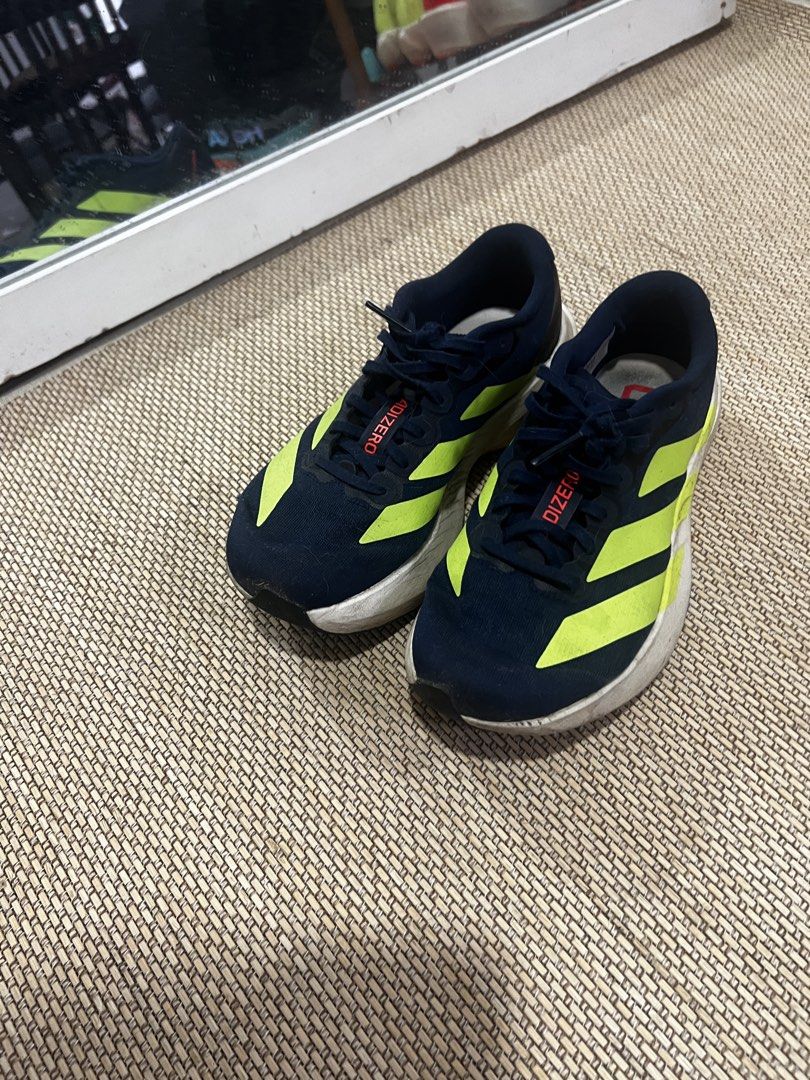 Adidas EVO SL US5.5 (Category: Sneakers) located in Manila. Submitted by binigurrl (Listing ID 1468991517, Image 1). Description: Evo SL (women) mileage: 100KM - Brand/Model: Adidas Adizero running shoes - Colorway: Navy blue with bright neon yellow stripes, red lettering on tongue and inner sole - Size: US 5.5, UK 4, FR 36 2/3 - Condition: Great daily trainers with tread remaining; white midsole has some dirt marks from previous runs - Ideal for