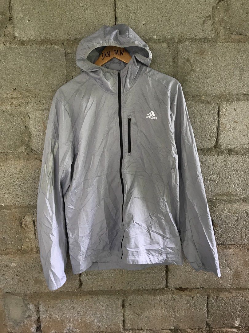 Adidas Grey Hooded Windbreaker Jacket Size L (Category: Coats, Jackets and Outerwear) located in Manila. Submitted by selme.finds (Listing ID 1468975005, Image 1). Description: - Brand: Adidas - Color: Grey - Size: Asia L (180/100A) - Material: Ribbed ripstop fabric - Features: Zip-up front, hood, and vertical zippered chest pocket - Style Code: GJ9949 - Production Date: 05/22 - Made in China - Condition: Excellent, ready to wear!.