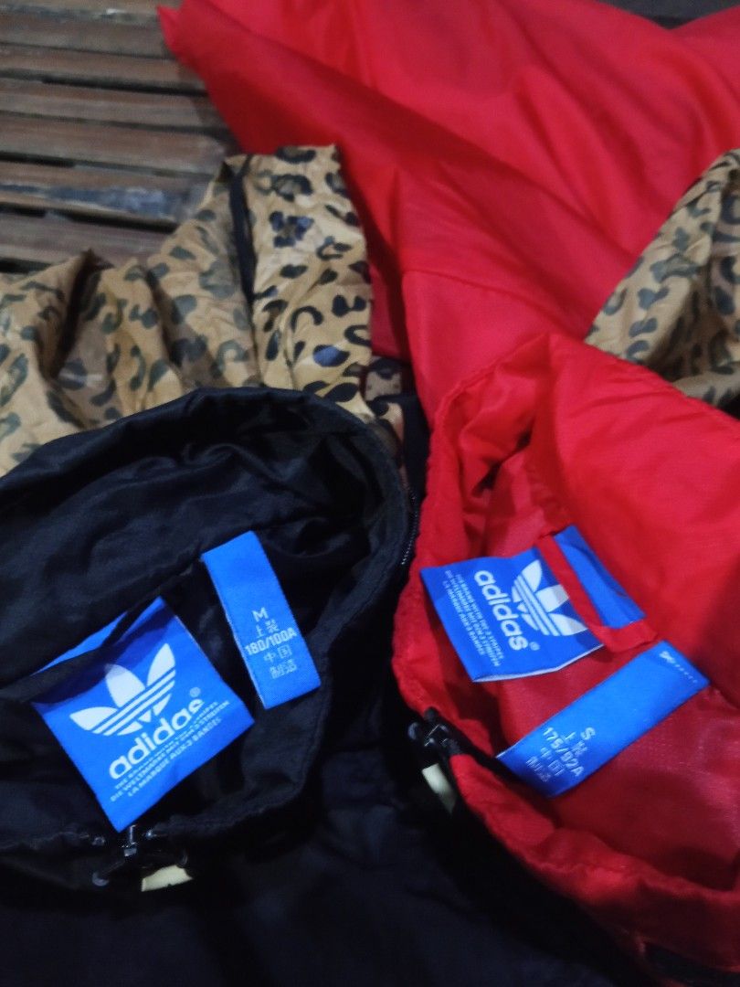 Adidas Leopard Hood Windbreaker Jacket Black Red (Category: Coats, Jackets and Outerwear) located in Lingayen. Submitted by rahzzelula73279 (Listing ID 1469150390, Image 3). Description: - Brand: Adidas - Items: 2 Windbreakers (Black & Red) - Sizes: Black (Medium), Red (Small) - Design: Bold leopard print hood, matching pocket accents, sleeve details, and back trefoil logo - Material: Nylon outer shell with comfortable polyester hood lining - Fea