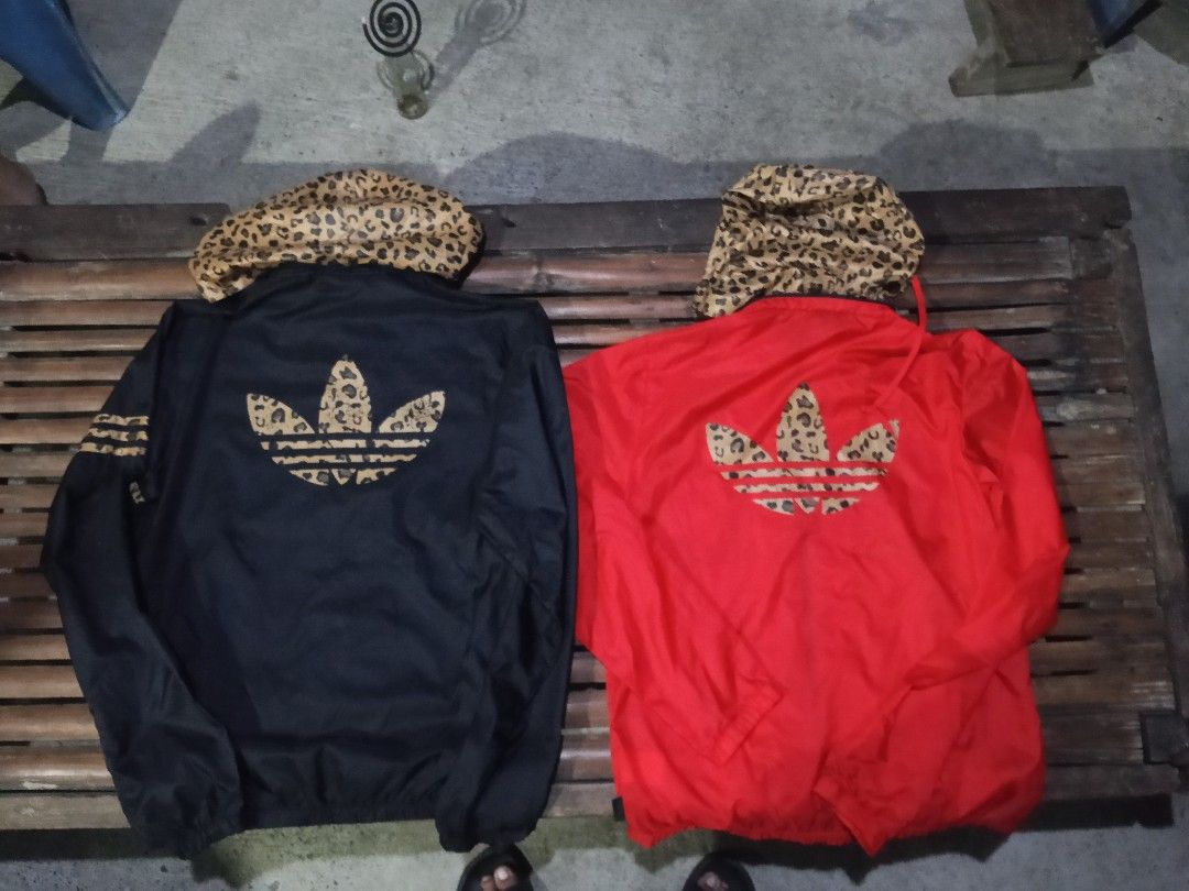 Adidas Leopard Hood Windbreaker Jacket Black Red (Category: Coats, Jackets and Outerwear) located in Lingayen. Submitted by rahzzelula73279 (Listing ID 1469150390, Image 2). Description: - Brand: Adidas - Items: 2 Windbreakers (Black & Red) - Sizes: Black (Medium), Red (Small) - Design: Bold leopard print hood, matching pocket accents, sleeve details, and back trefoil logo - Material: Nylon outer shell with comfortable polyester hood lining - Fea