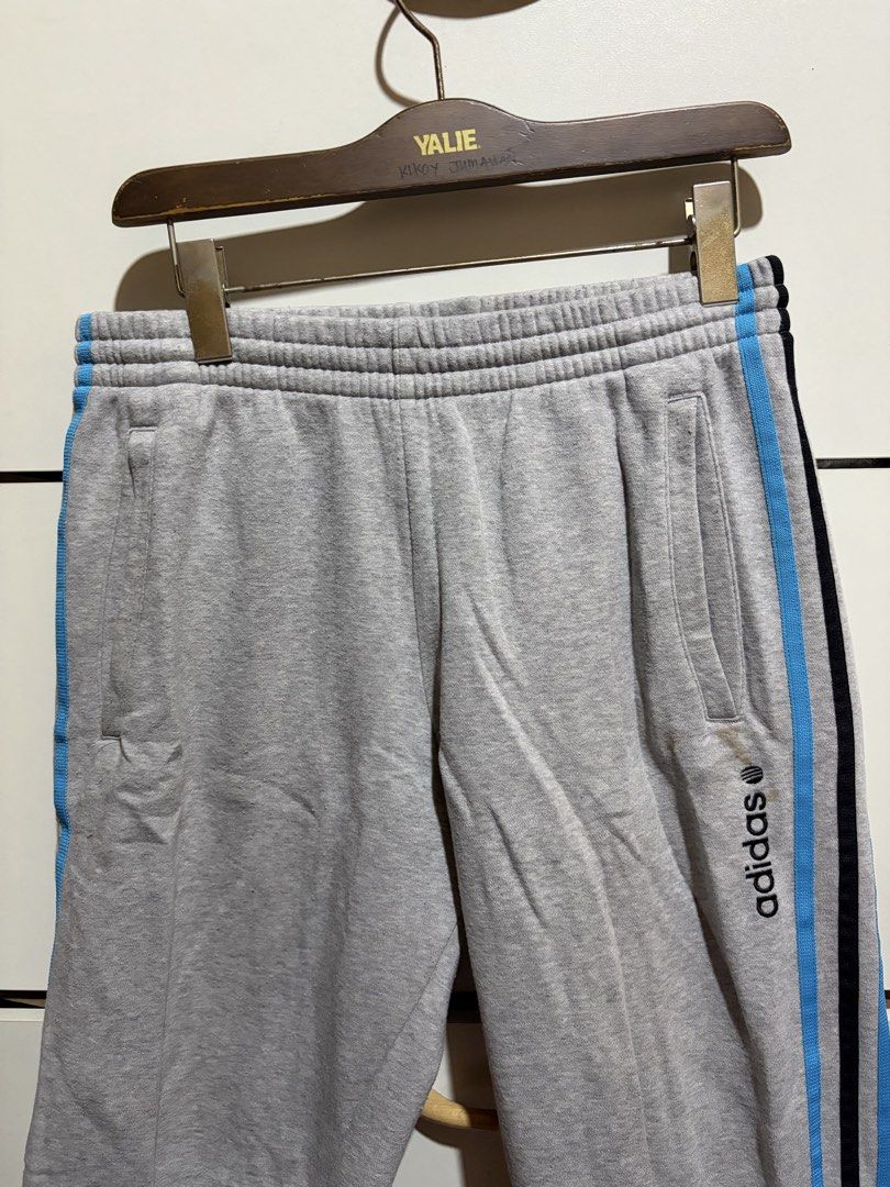 Adidas Neo Label Grey Sweatpants Size M (Category: Activewear) located in Siquijor. Submitted by yhostuff (Listing ID 1469007842, Image 2). Description: - Brand: Adidas Neo Label - Item: Sweatpants with blue & black side stripes - Size: M (175/80A) - Details: Drawstring waistband with branded tips, embroidered logo near front pocket - Condition: Good, with a small ( WASHABLE )stain on the left leg near the logo. P.S. Visit my listing add another 