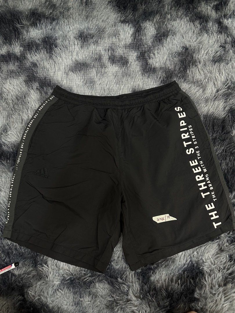 Adidas The Three Stripes Black Shorts (Category: Shorts) located in Quezon City. Submitted by nichole12 (Listing ID 1469089788, Image 1). Description: - Authentic Adidas black shorts - Comfortable elastic waistband - Bold white 'The Three Stripes' text down the leg - Small embroidered Adidas logo near the hem - Convenient back pocket with the classic three-stripes design - Smooth, premium fabric ideal for workouts or daily casual wear.