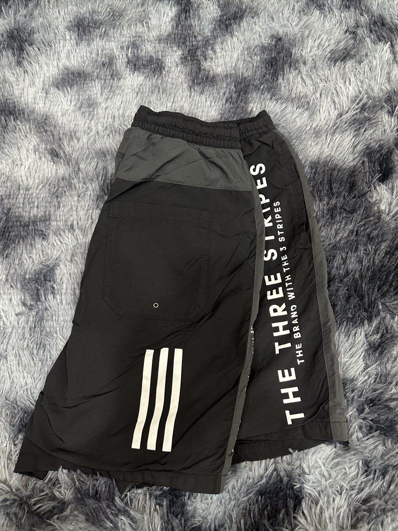 Adidas The Three Stripes Black Shorts (Category: Shorts) located in Quezon City. Submitted by nichole12 (Listing ID 1469089788, Image 2). Description: - Authentic Adidas black shorts - Comfortable elastic waistband - Bold white 'The Three Stripes' text down the leg - Small embroidered Adidas logo near the hem - Convenient back pocket with the classic three-stripes design - Smooth, premium fabric ideal for workouts or daily casual wear.
