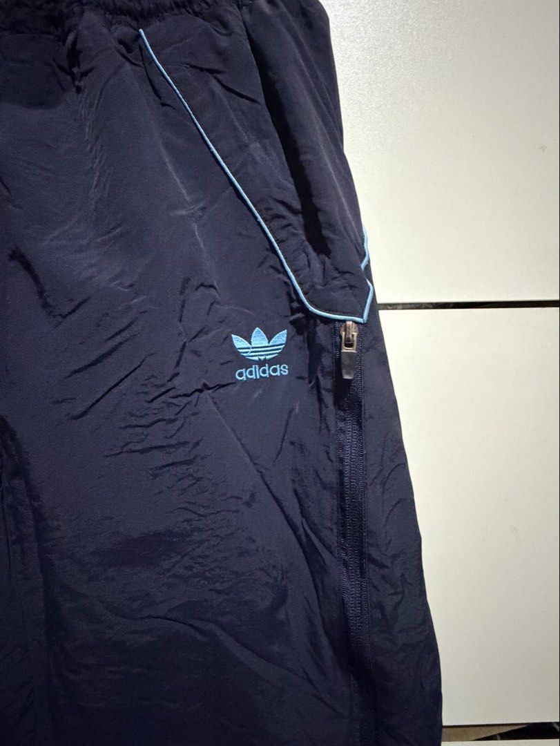 Adidas Wears Track Pants Navy Blue (Category: Activewear) located in Siquijor. Submitted by yhostuff (Listing ID 1469010138, Image 2). Description: - Color: Dark navy blue with light blue piping - Features: Zippered pockets & comfy elastic waistband - Detail: Lime green 'adidas wears' logo hit on the back - Style: Classic retro vibe - Condition: Good staple piece for everyday sporty fits P.S. Visit my listing add another item/s for a lesser price