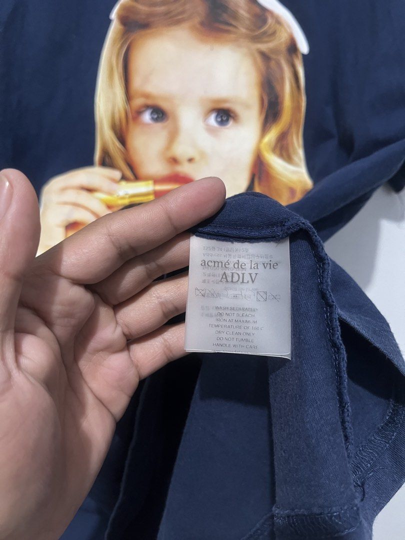 ADLV (Category: Activewear) located in Cebu City. Submitted by thrift.sht (Listing ID 1468985109, Image 3). Description: Brand: Acme De La Vie (ADLV) - Korean Hype Brand Design: Baby Face Lipstick Girl - Iconic! Color: Navy Blue - Rare! Size: 2 (Fits L-XL Oversized) Condition: 9/10 - Print goods, small crack, color deep Fabric: Thick cotton 📍 Cebu City J&T / Maxim #ADLV #AcmeDeLaVie #ADLVPH #KoreanStreetwear #StreetwearPH #CebuUkay.