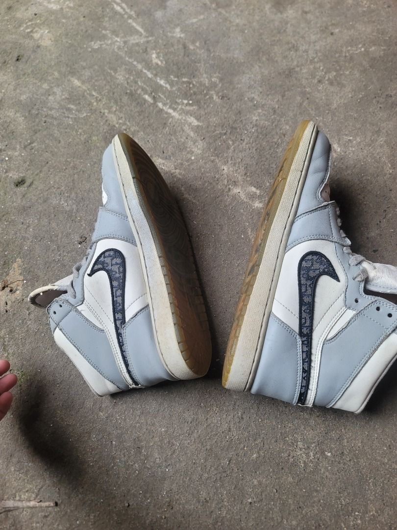 Air Jordan 1 High OG Dior Grey White (Category: Sneakers) located in Caloocan City. Submitted by remwil18 (Listing ID 1468934633, Image 2). Description: - Model: Air Jordan 1 High x Dior - Colorway: Wolf Grey / White with Dior monogram swoosh - Size: UK 8 / EUR 42.5 / CM 27 - Details: Translucent rubber outsoles with DIOR branding, Made in Italy tag inside collar - Condition: Noticeable wear on midsoles, outsoles, and upper crease.