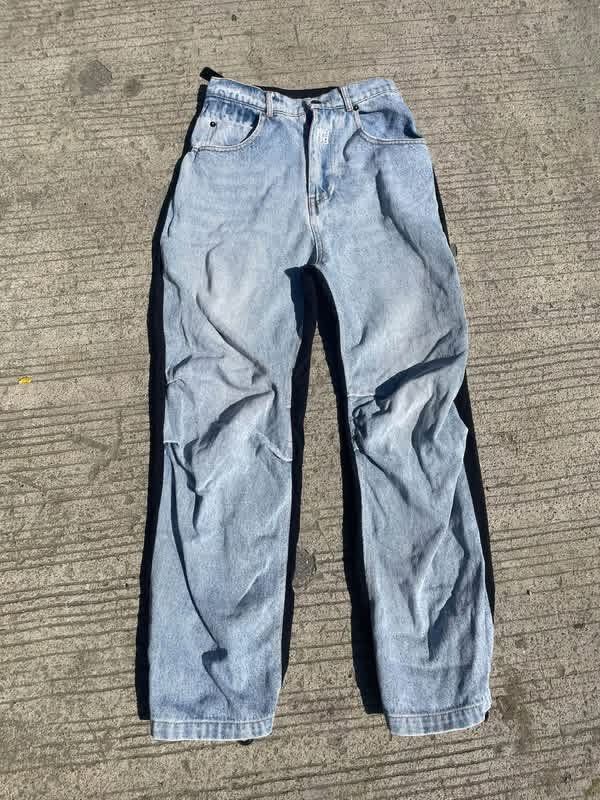Alexander Wang denim and nylon cargo pants (Category: Jeans) located in Manila. Submitted by declutterwithme07 (Listing ID 1469024137, Image 1). Description: - Brand: Alexander Wang - Style: Hybrid cargo pants with a unique layered design - Material: Light wash denim front and black nylon back - Fit: Loose and relaxed streetwear fit - Features: Adjustable waist buckles, multiple cargo pockets, and drawstring hems - Authenticity: Label clearly vis