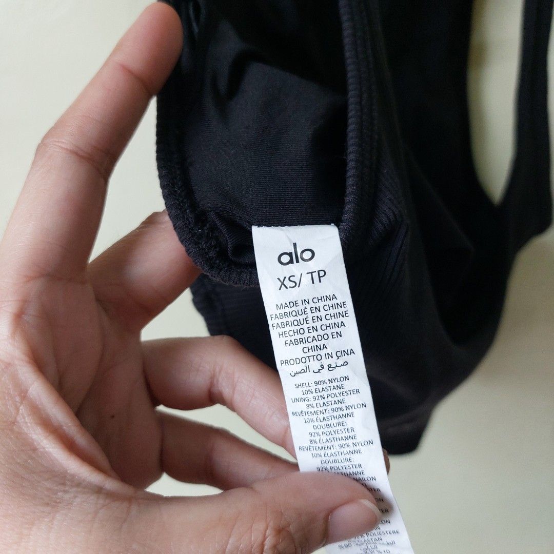 Alo Yoga Rib cropped (Category: Sleeveless) located in Quezon City. Submitted by lovedcollection_2020 (Listing ID 1469118127, Image 3). Description: - Color: Black - Size: Extra Small (XS) - Style: Ribbed crop top with high mock neck and sleeveless cut - Feature: Built-in padding (no bra needed) - Fit: Fitted silhouette, stretchy fabric - Condition: Excellent.
